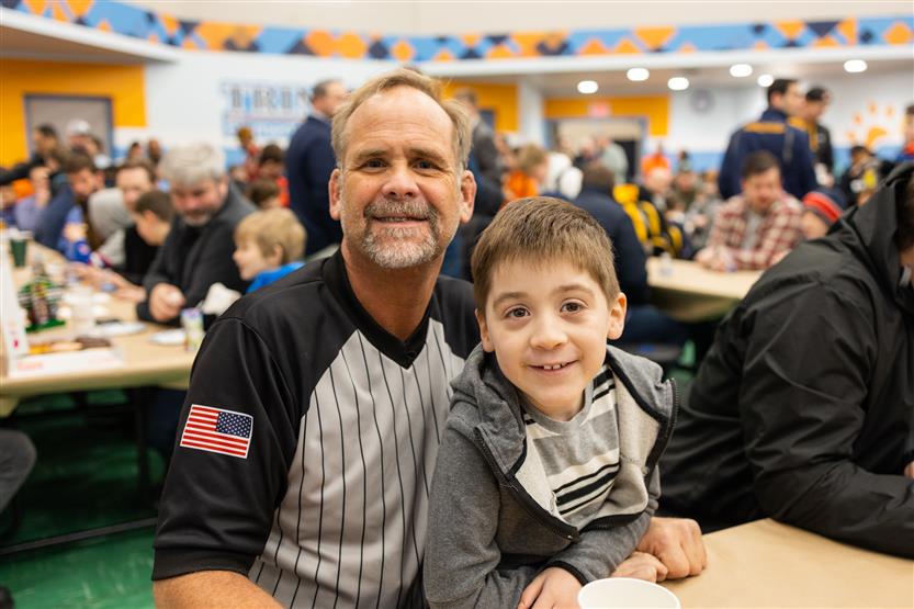 Trinity Elementary students eat donuts with dudes
